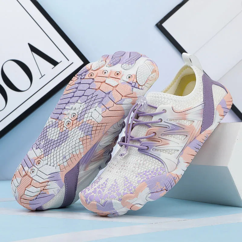 A pair of quick-drying lace-up beach shoes in a mesh material with a rubber non-slip sole.