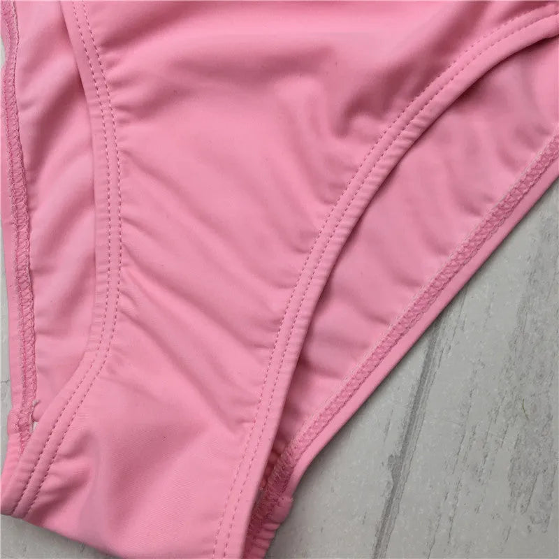 Women's pink cut out halter bikini swimsuit with bandage design and cross front details