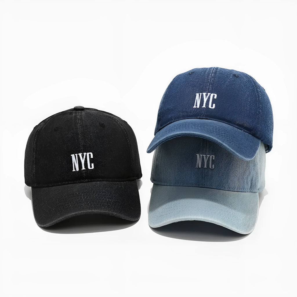 Light blue denim baseball cap with dome crown and printed alphabet letters on the front.