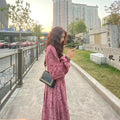 Red knitted cotton floral dress with princess sleeves and an elastic high waist.