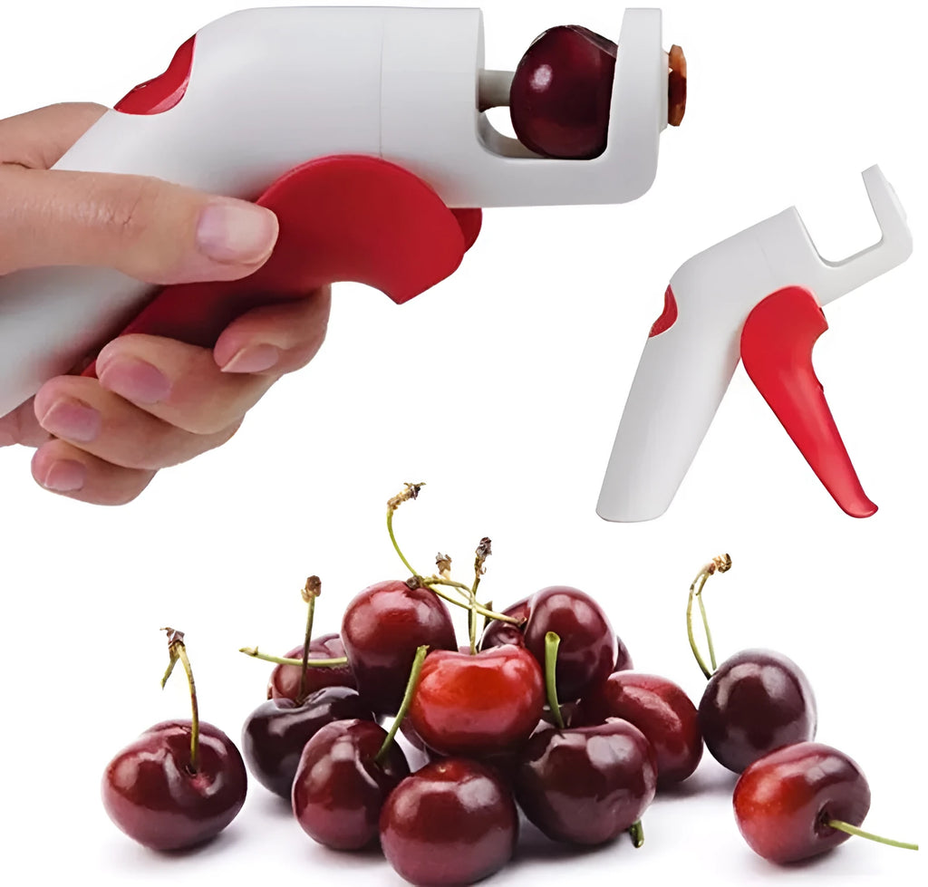 Manual cherry pitter tool with stainless steel coring mechanism on a kitchen worktop.