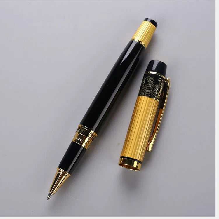Black metal fountain pen with iridium nib and patterned orb design, shown on a desk