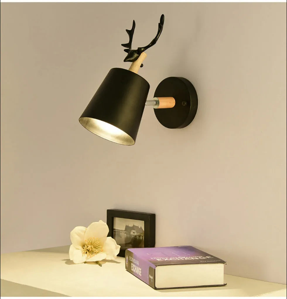 Modern antler wall lamp in black finish with iron and wood construction, measuring 24x29cm