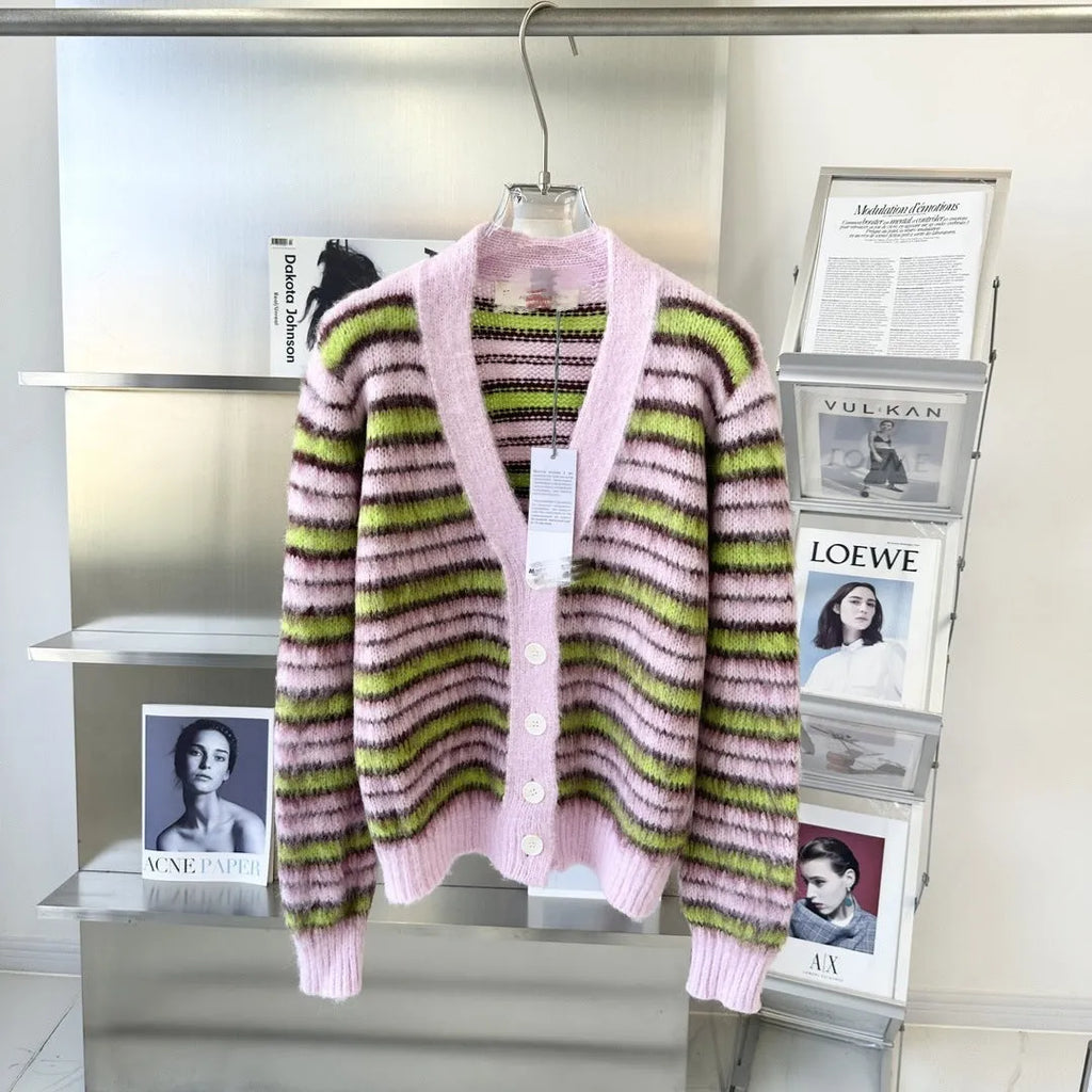 Pink wool knitted cardigan sweater with round collar on a hanger