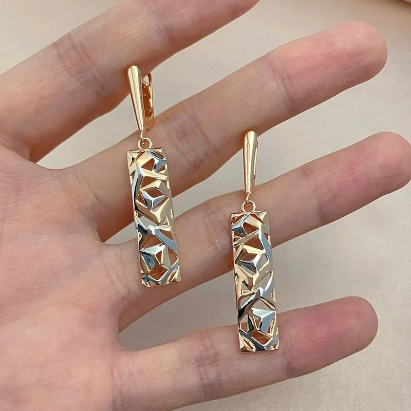A pair of rectangular two-tone hollow stud earrings with a geometric design and picture-style colour finish.