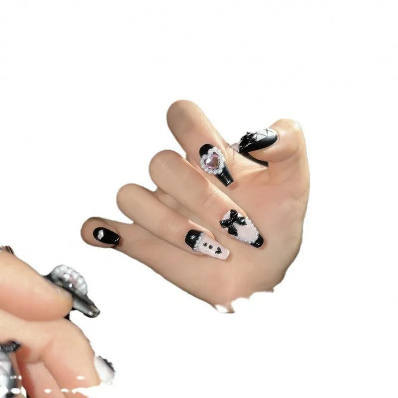 Hand-painted black peach heart artificial nails with bow design in four sizes