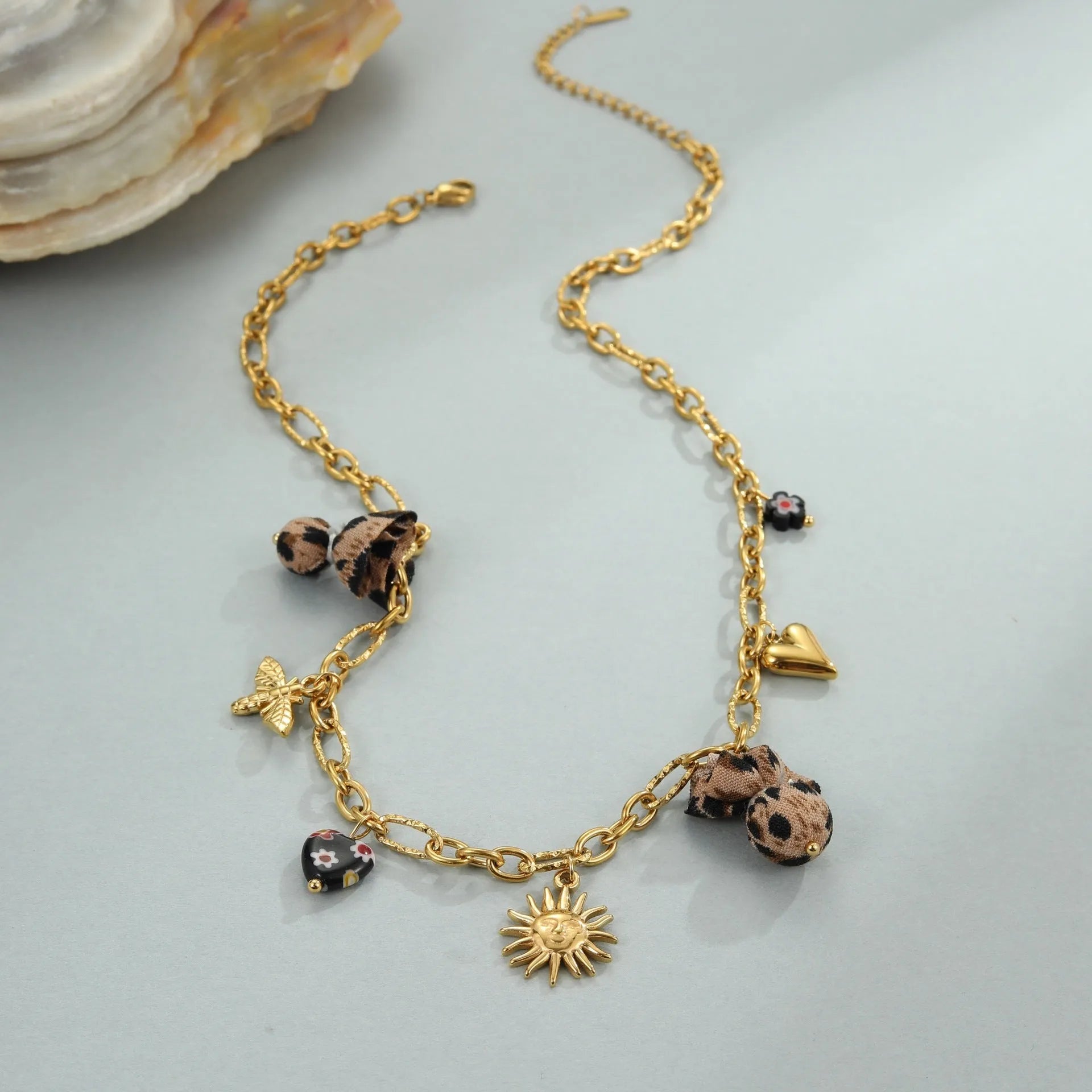 Geometric leopard pendant necklace with love heart and flower engravings on gold-plated chain