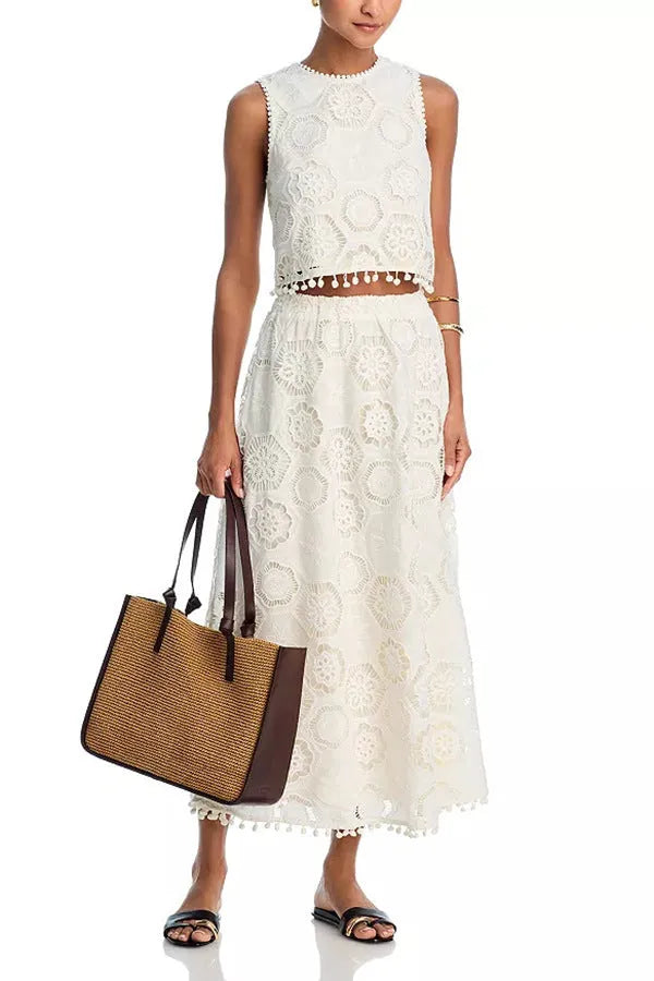 White women's retro style suit set with sleeveless top and embroidered long skirt