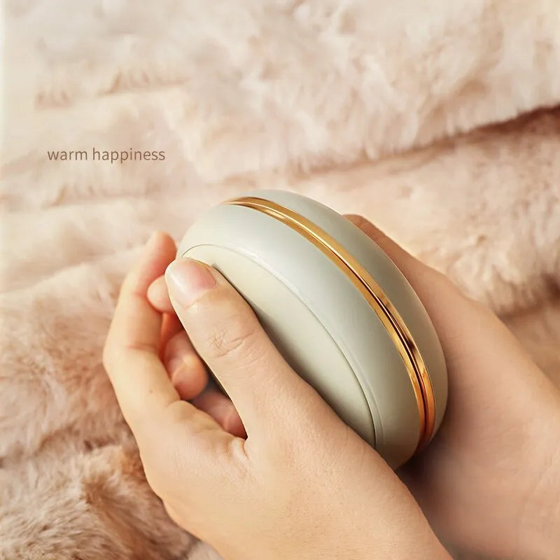 Brown portable USB power bank with hand warmer function showing size alongside data cable and velvet bag.
