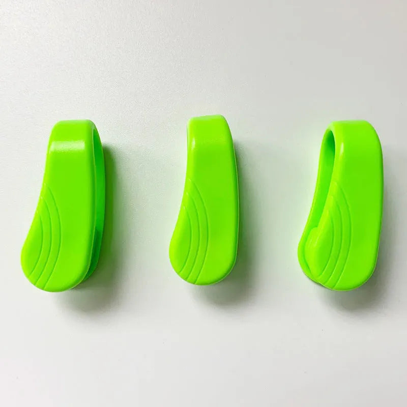 Tiger mouth massage clip multi-function acupoint massager in black on a hand, showing placement between thumb and index finger