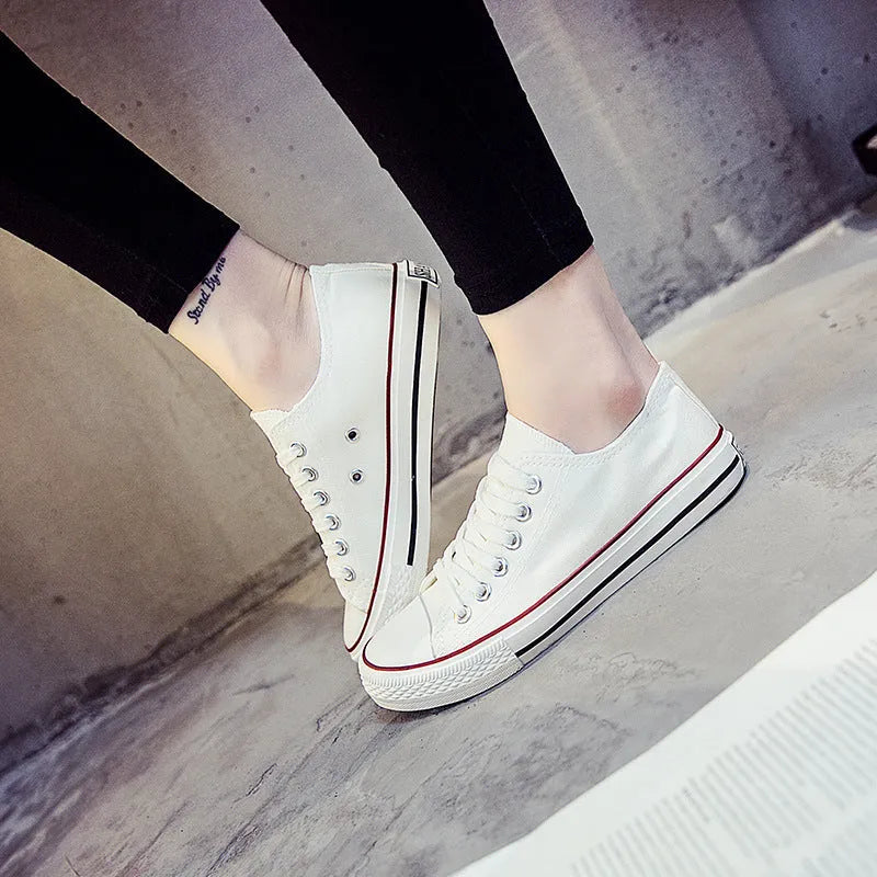 Women's casual lace-up canvas shoes in solid colours on a white background.