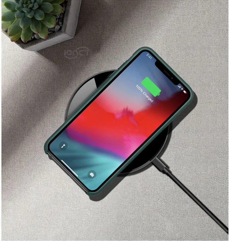 Black QI wireless charging pad with smooth surface and silicone non-slip base for 15W fast charging