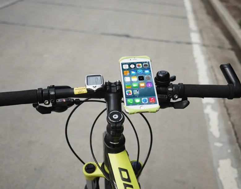 A black silicone bicycle phone holder mounted on a bike handlebar, showing the three adjustment holes and buckle fastener.