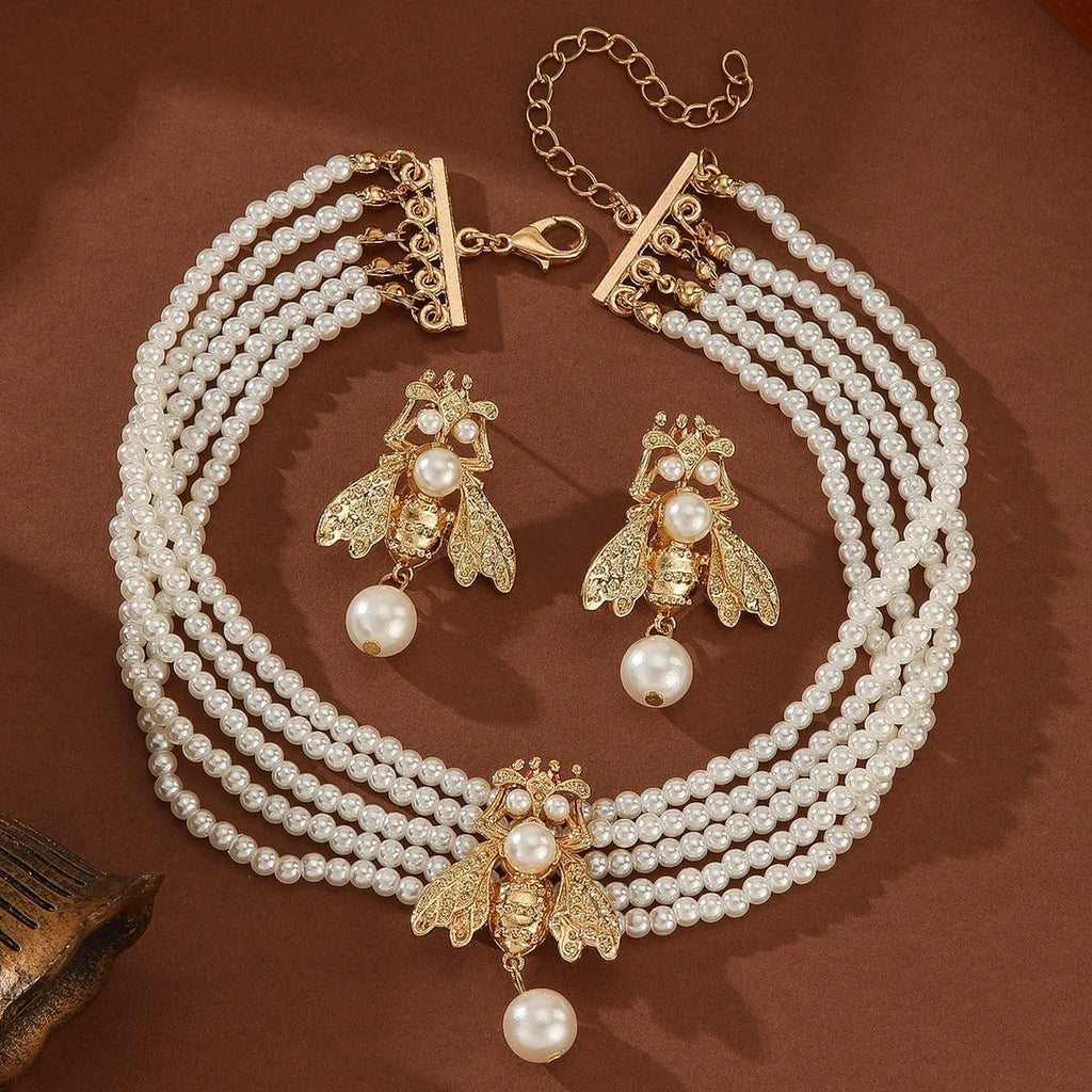 Golden bee earrings and necklace set on display with alloy pendant and regular chain