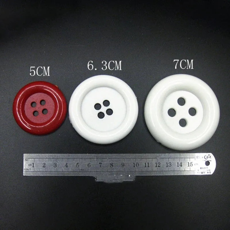 Assortment of oversized round plastic buttons in multiple colours with four holes.