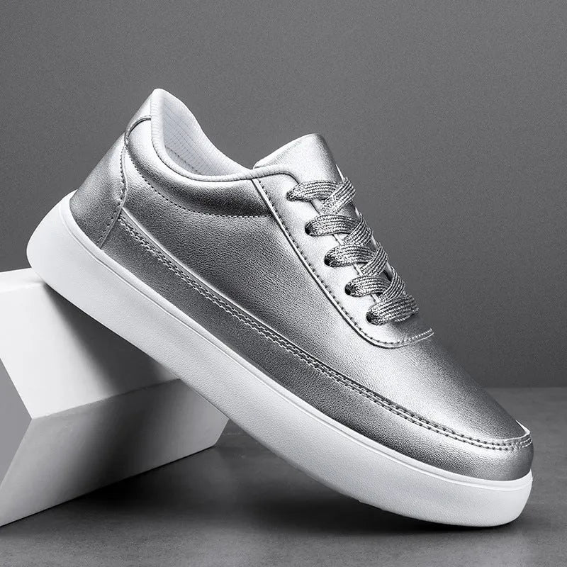 Women's white leather flat lace-up casual shoes on a plain background.