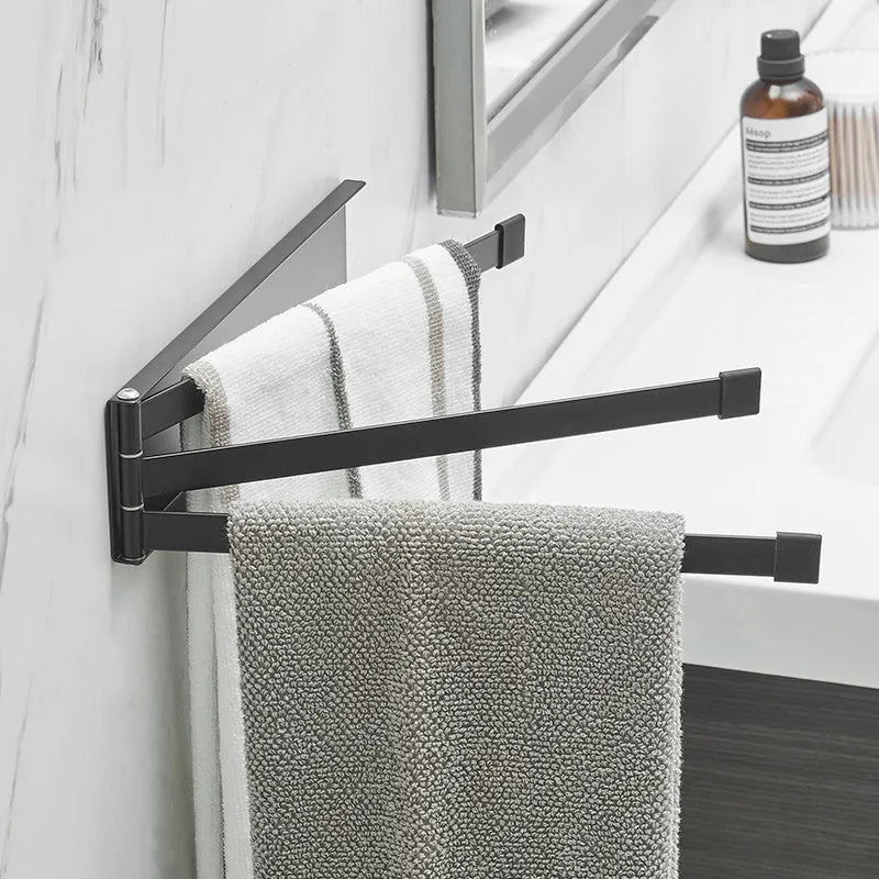 Black folding no-drill towel bar mounted on a bathroom wall with adhesive.