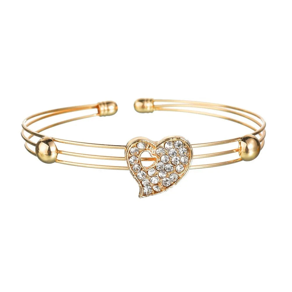 Gold alloy jewellery set with love heart, water drop, and bell pendants including earrings, necklace, and bracelet