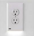 White socket induction night light plugged into wall outlet with automatic light sensor.