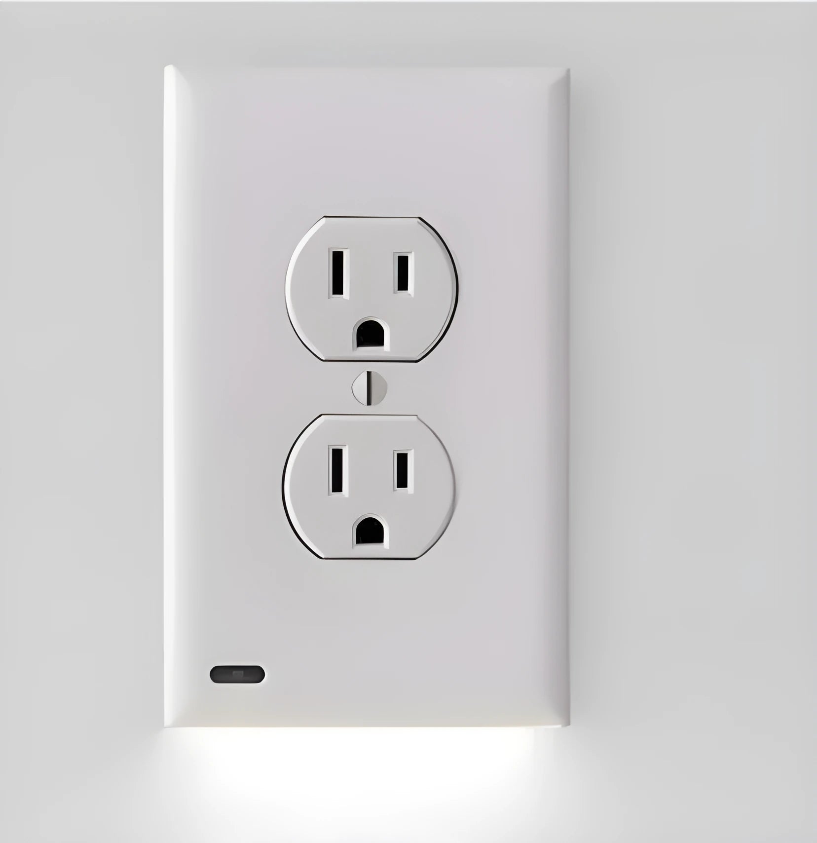 White socket induction night light plugged into wall outlet with automatic light sensor.