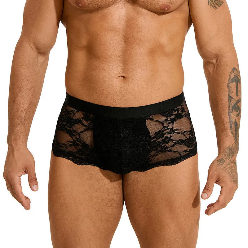 Men's black lace briefs with a hollow-out, see-through pattern laid flat.