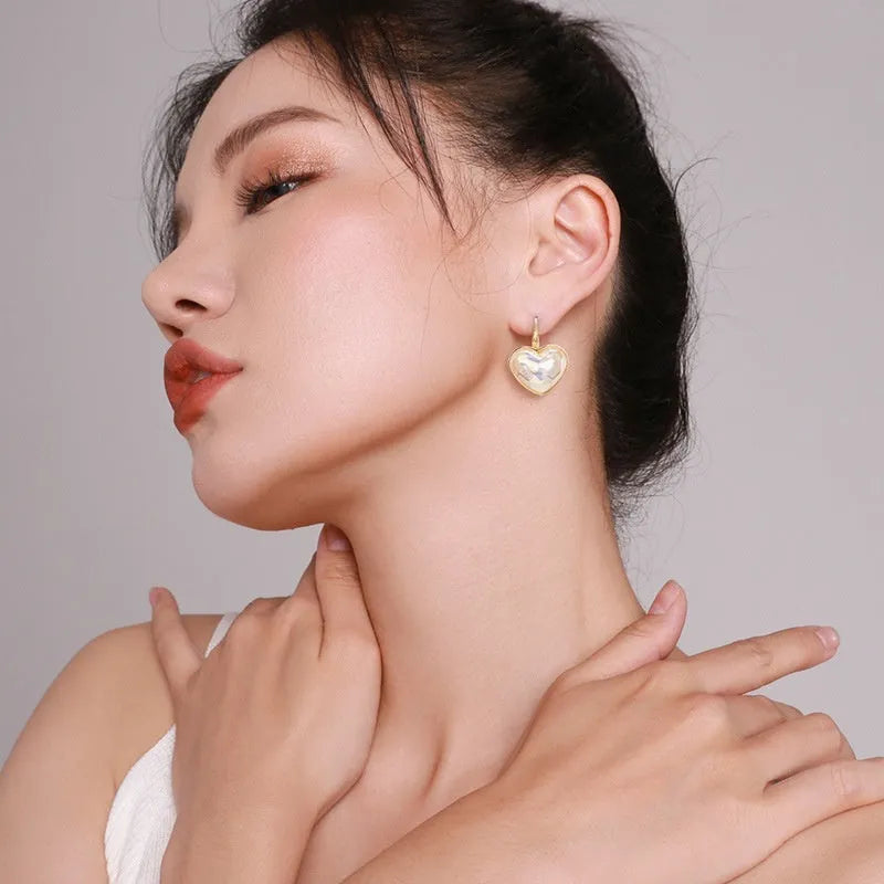Pair of gold-coloured alloy clip-on earrings with a fashion niche design for women.
