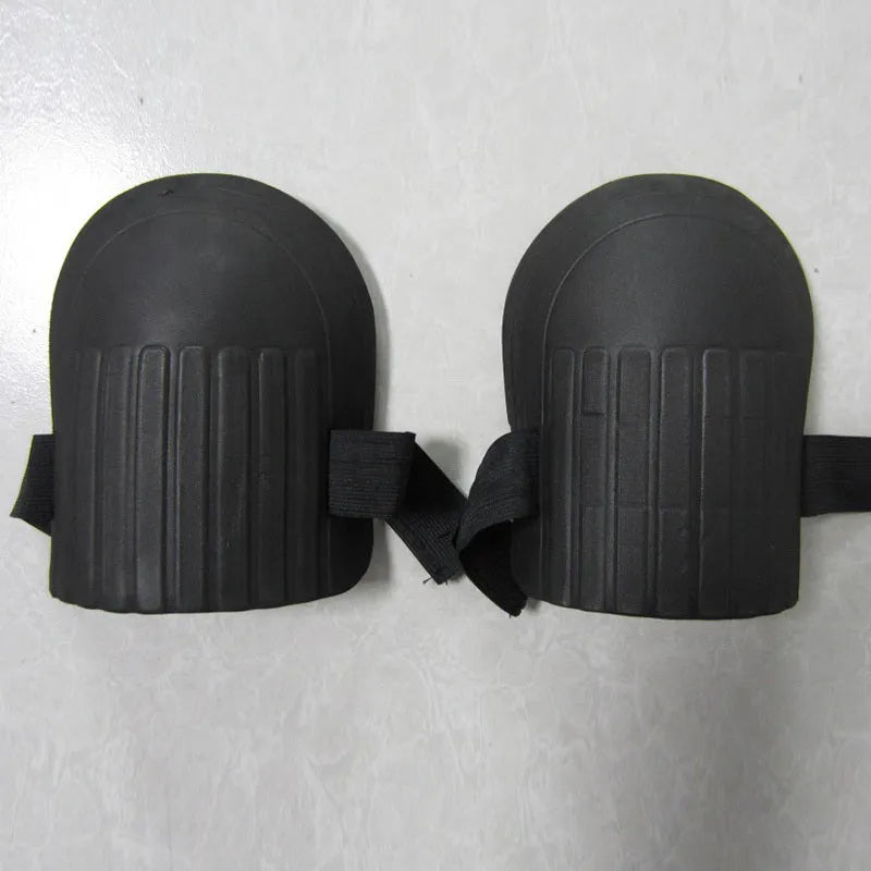 A pair of thick EVA foam knee pads in army green colour, shown on a wooden surface.