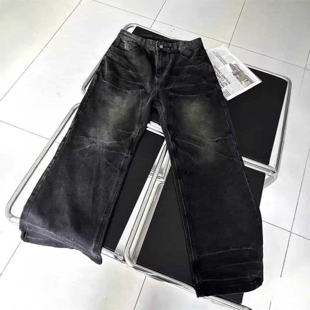 Washed black straight denim trousers with deconstructed dirty mud texture and zipper fly