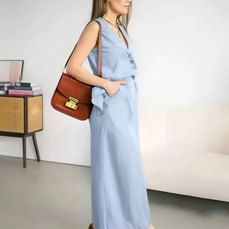 Blue sleeveless vest and matching long skirt two-piece set laid flat.
