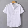 Men's beige loose-fit linen casual shirt with a stand collar and short sleeves on a hanger.
