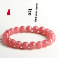Women's geometric Rhodochrosite crystal bracelet with Longevity Lock feature on a wrist, showing red patterned stone beads.