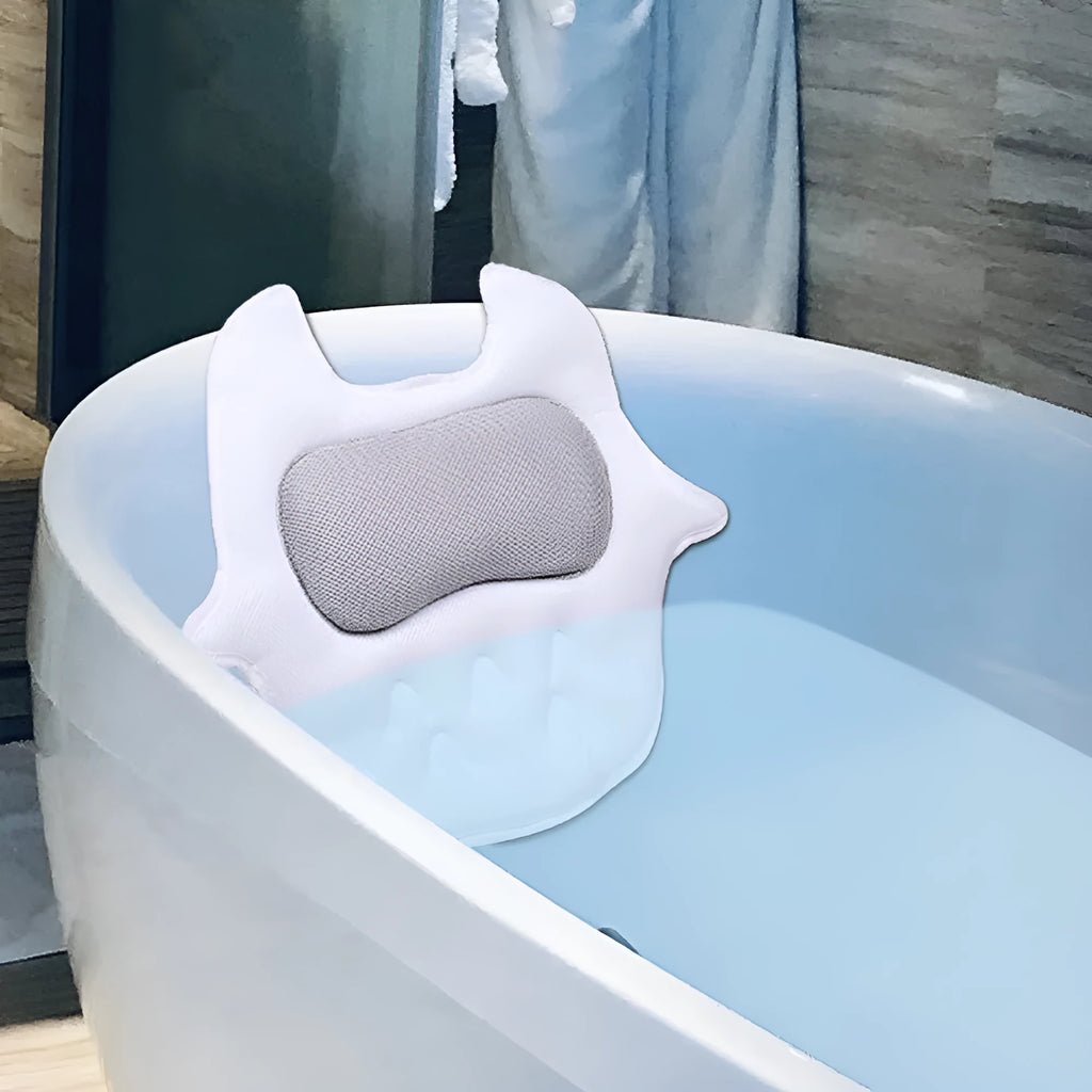 White ergonomic bathtub pillow with owl shape, 5D mesh fabric, and strong suction cups on a smooth bath surface