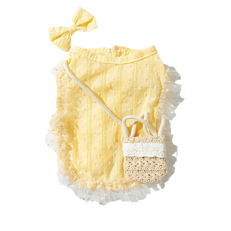 Small dog wearing yellow two-tone country shoulder bag outfit with matching bow and woven crossbody bag