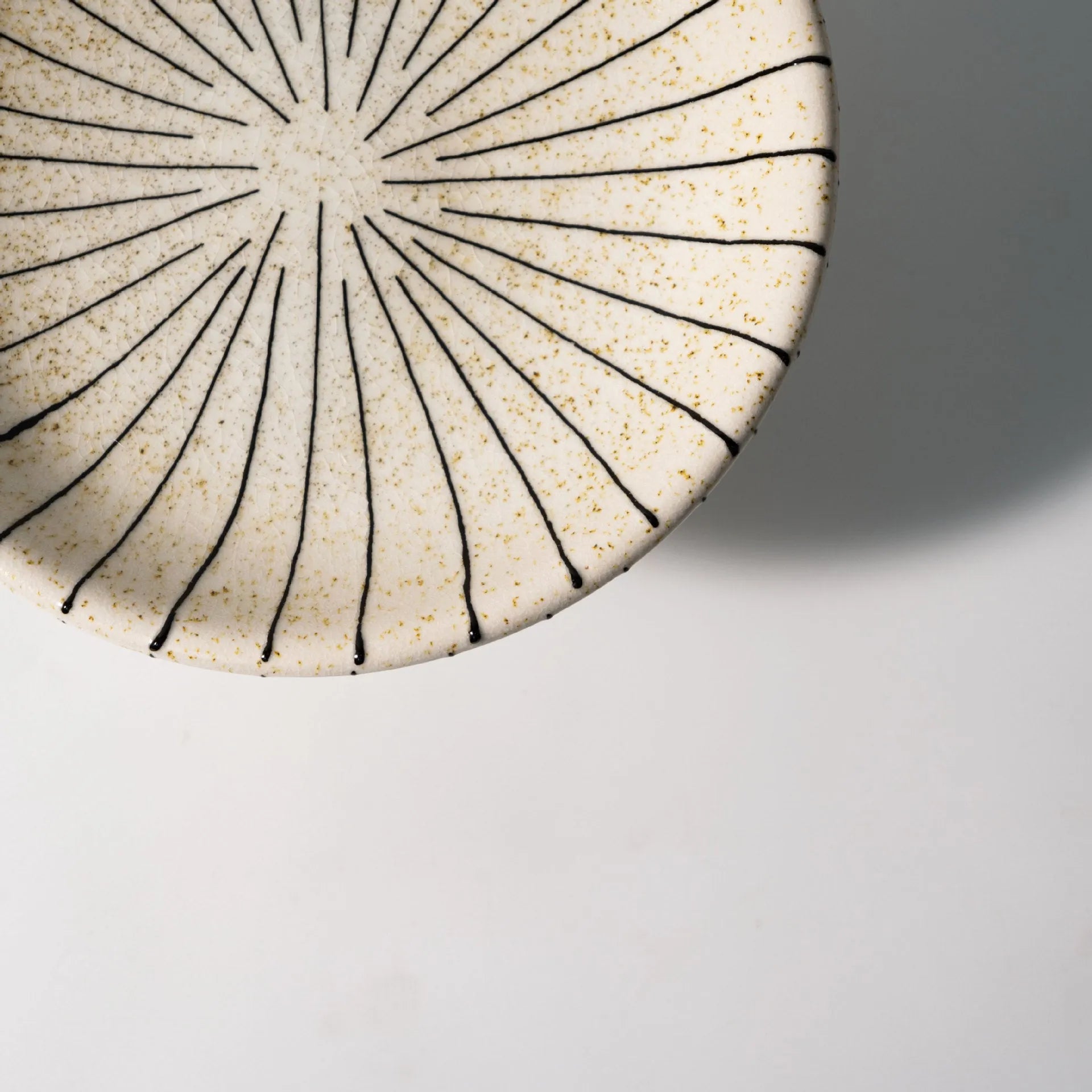 Black and white striped synthetic resin fruit plate on table
