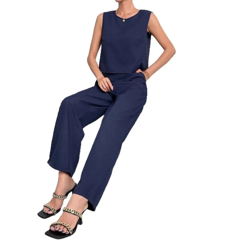 Red polyester women's two-piece set with sleeveless top and wide-leg trousers laid flat.