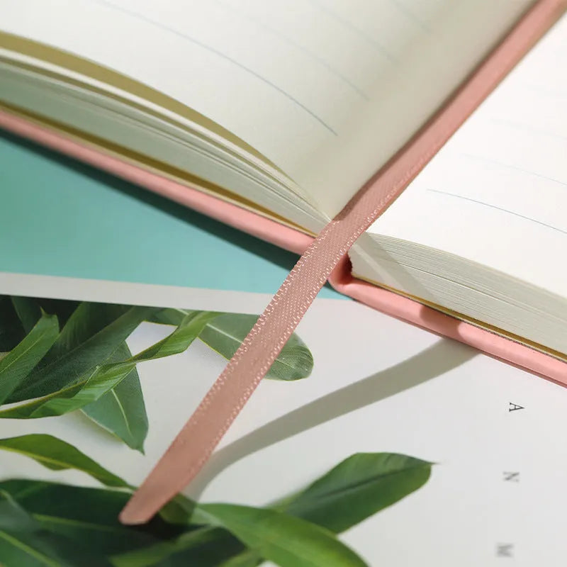 A5 tactile PU hardcover notebook with 96 sheets of 100gsm white paper and sewn adhesive binding, shown in available cover colours.