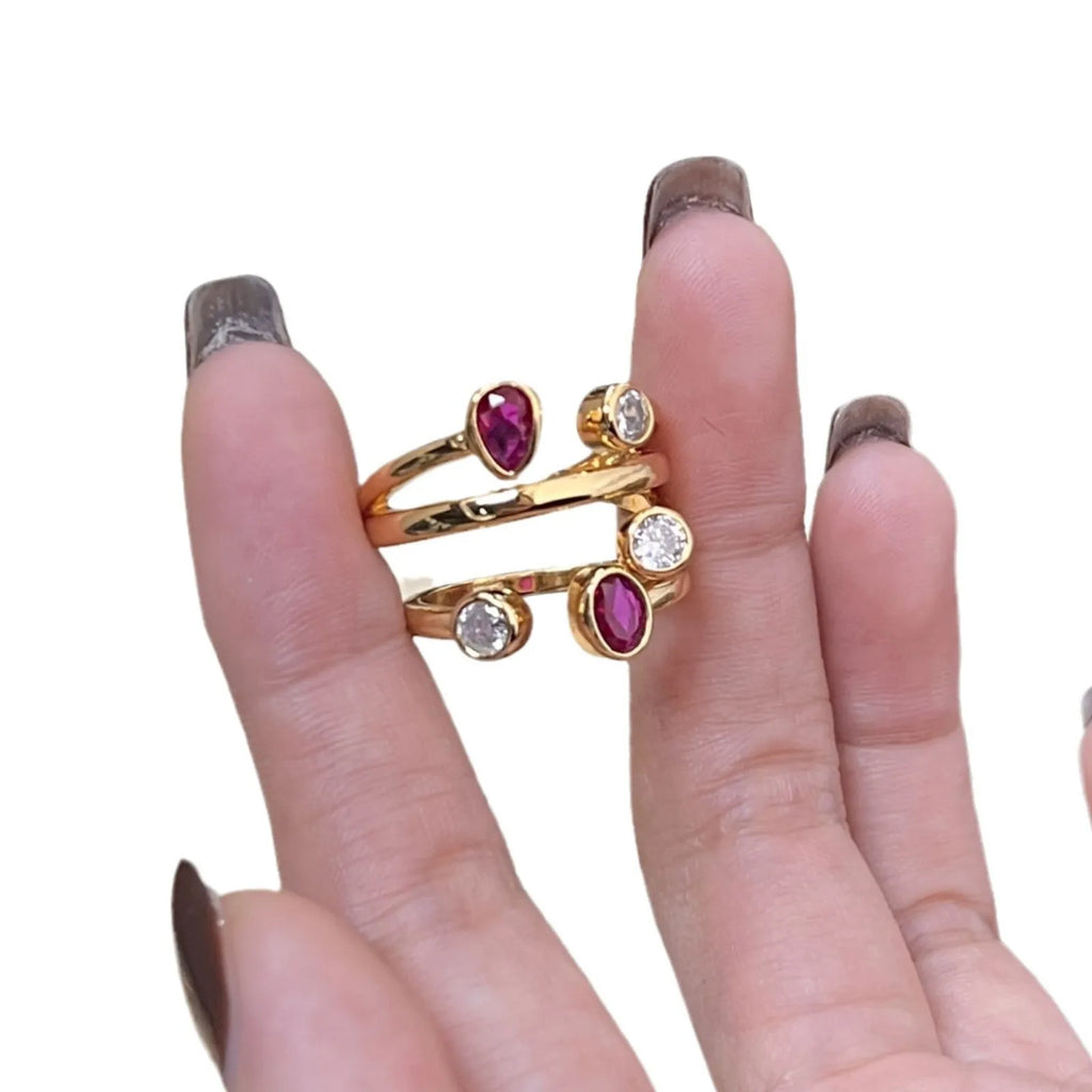 Geometric two-tone ring with an irregular cross design and group diamond details on a copper band.