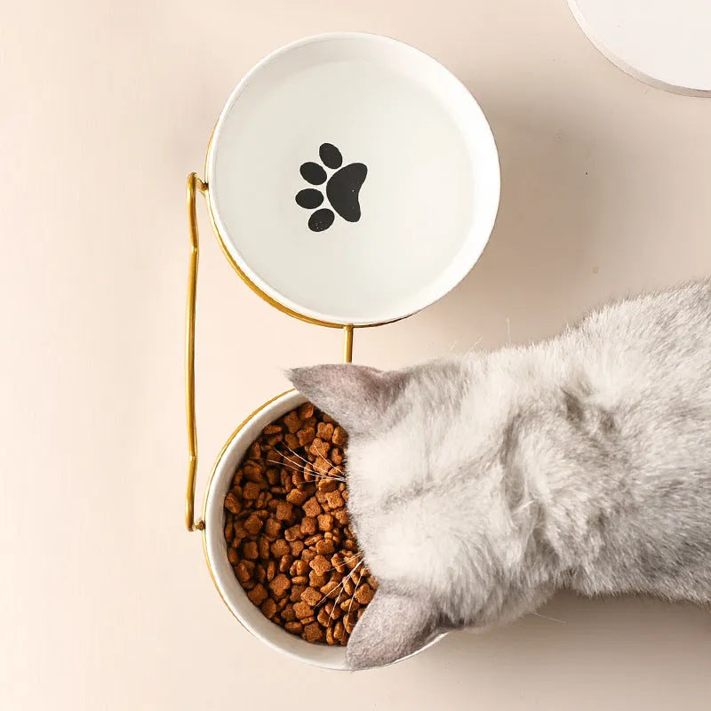 White ceramic pet bowl with cat footprint pattern in black metal frame