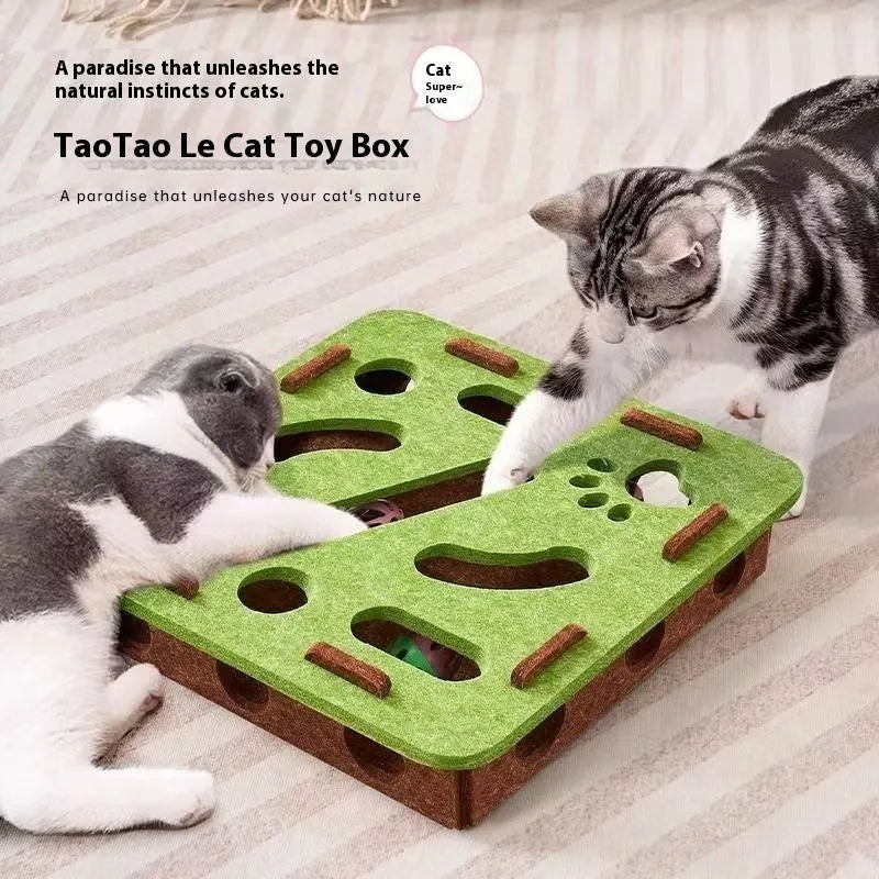 Green brown felt cube cat scratching toy with a square hole in the centre panel.