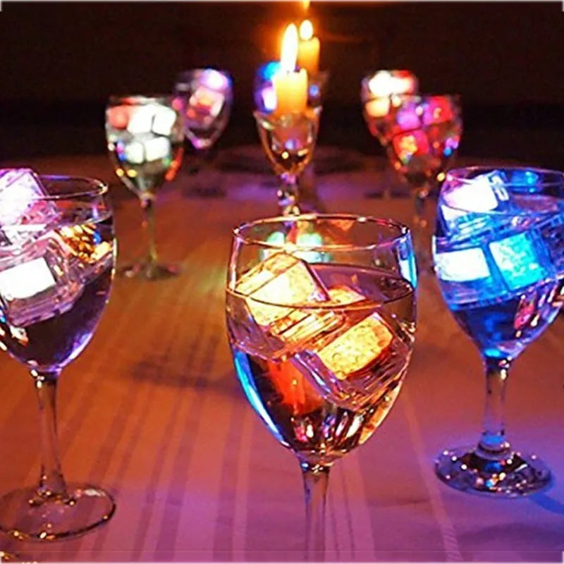 Square food-grade LED light ice cube glowing in a clear drink with colourful illumination