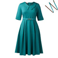 A woman wearing a solid colour African dress with half sleeves and a high waist, featuring a matching belt.