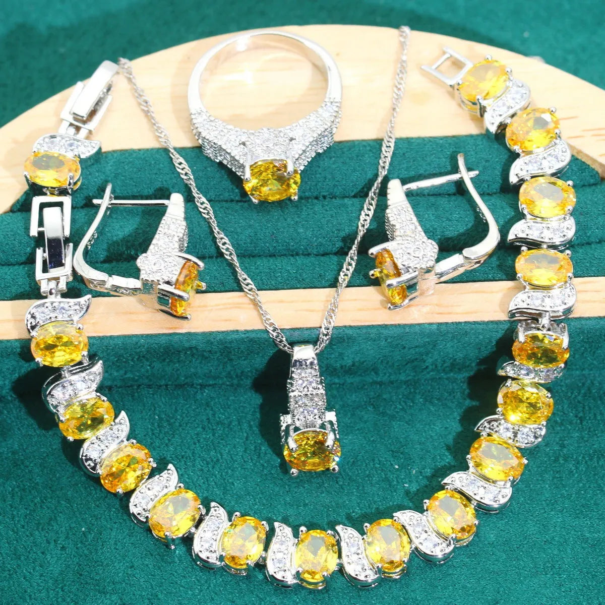 Four-piece bridal jewellery set showing zircon necklace, bracelet, earrings, and ring in coordinating design
