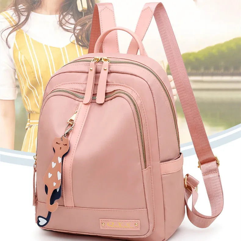 Women's black nylon casual backpack with double shoulder straps and front pocket