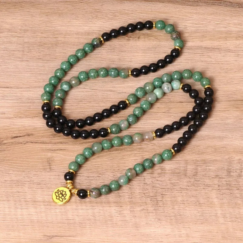 Green and black elastic beaded alloy bracelet showing stretch design and natural style