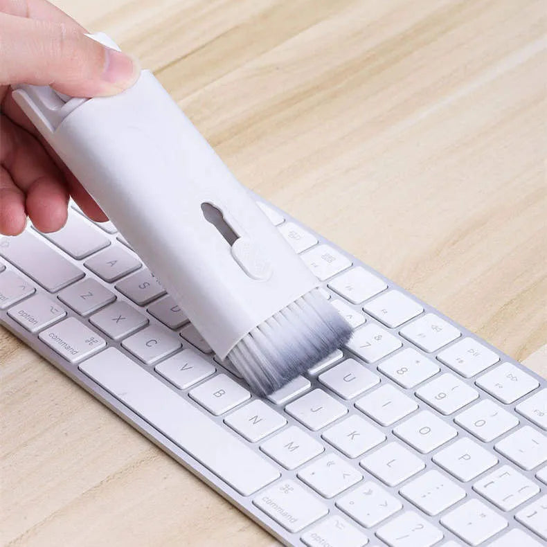 Multifunctional cleaning kit with a double-headed pen, retractable brush, and spray bottle on a white background