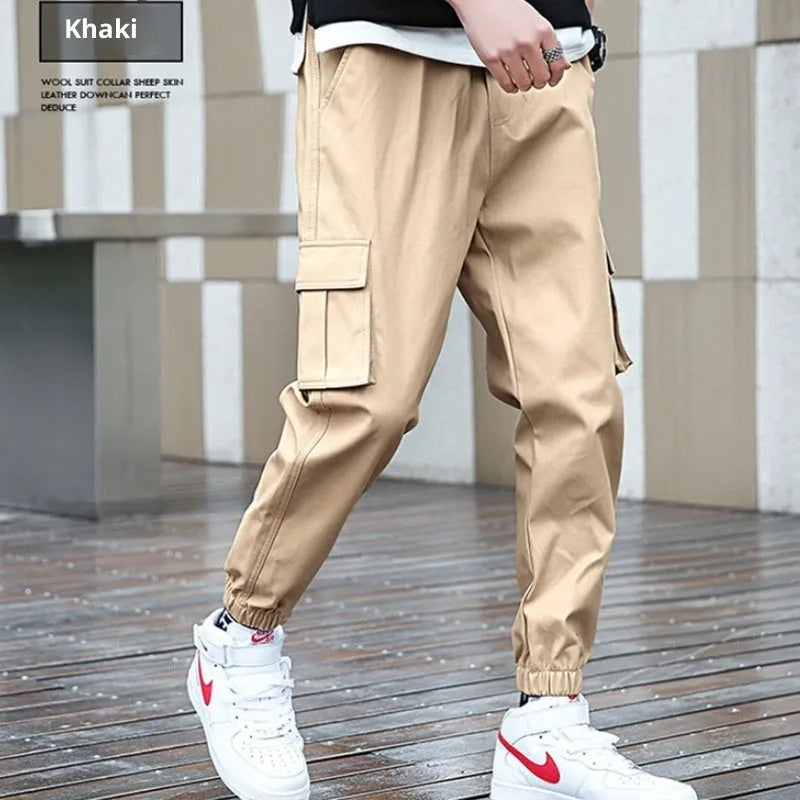 Khaki multi-pocket harem trousers with tapered mid-waist and elastic waistband, polyester fabric