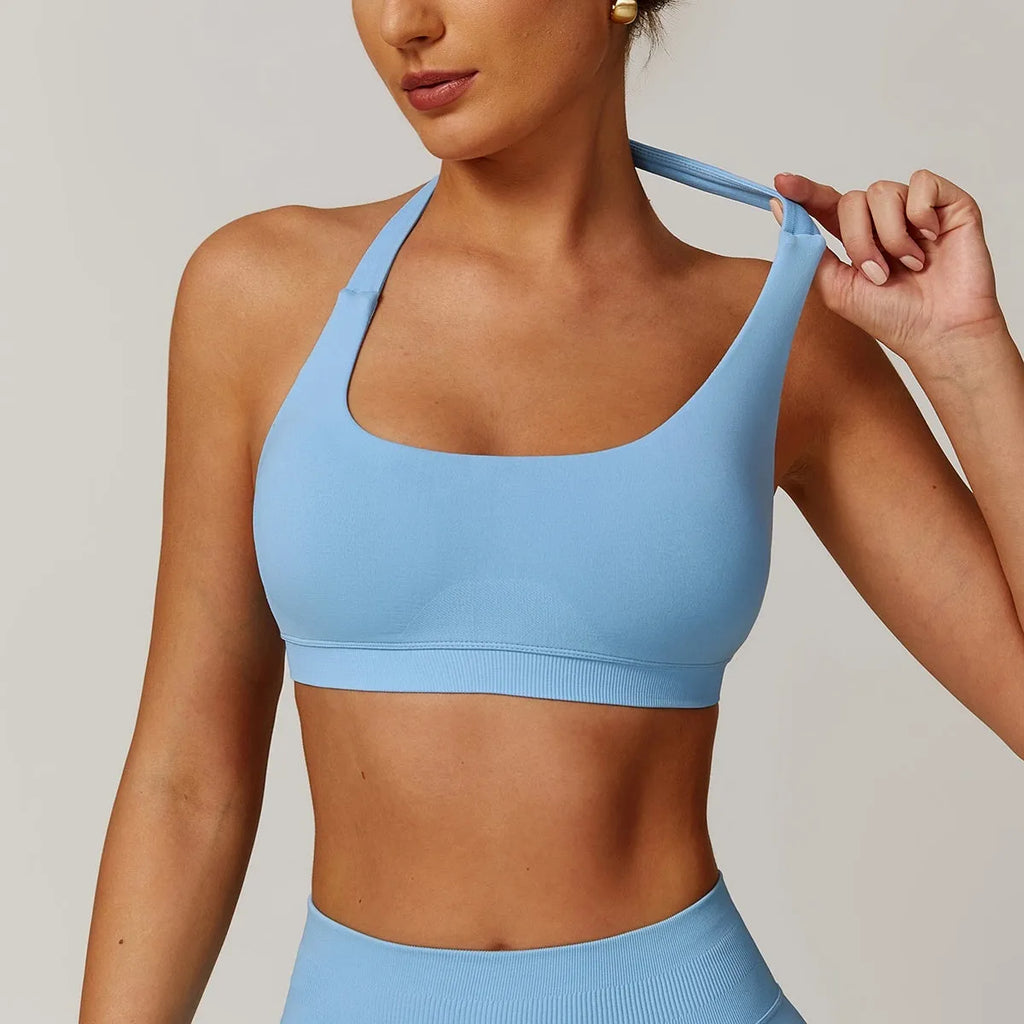 Women's black halter sports bra with hollow back and removable pads for yoga and workouts