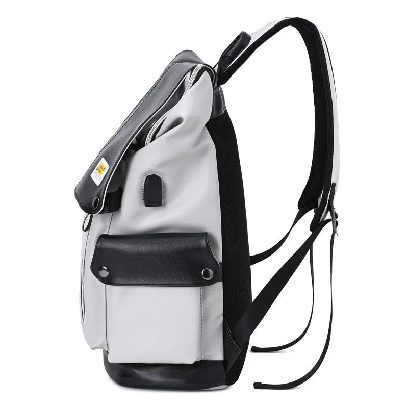 Large-capacity black water-resistant PU leather backpack for students, 16-inch size, featuring curved shoulder straps and solid colour finish