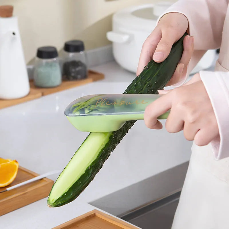 Dark green kitchen peeler with storage tube and stainless steel blade for fruit and vegetable peeling