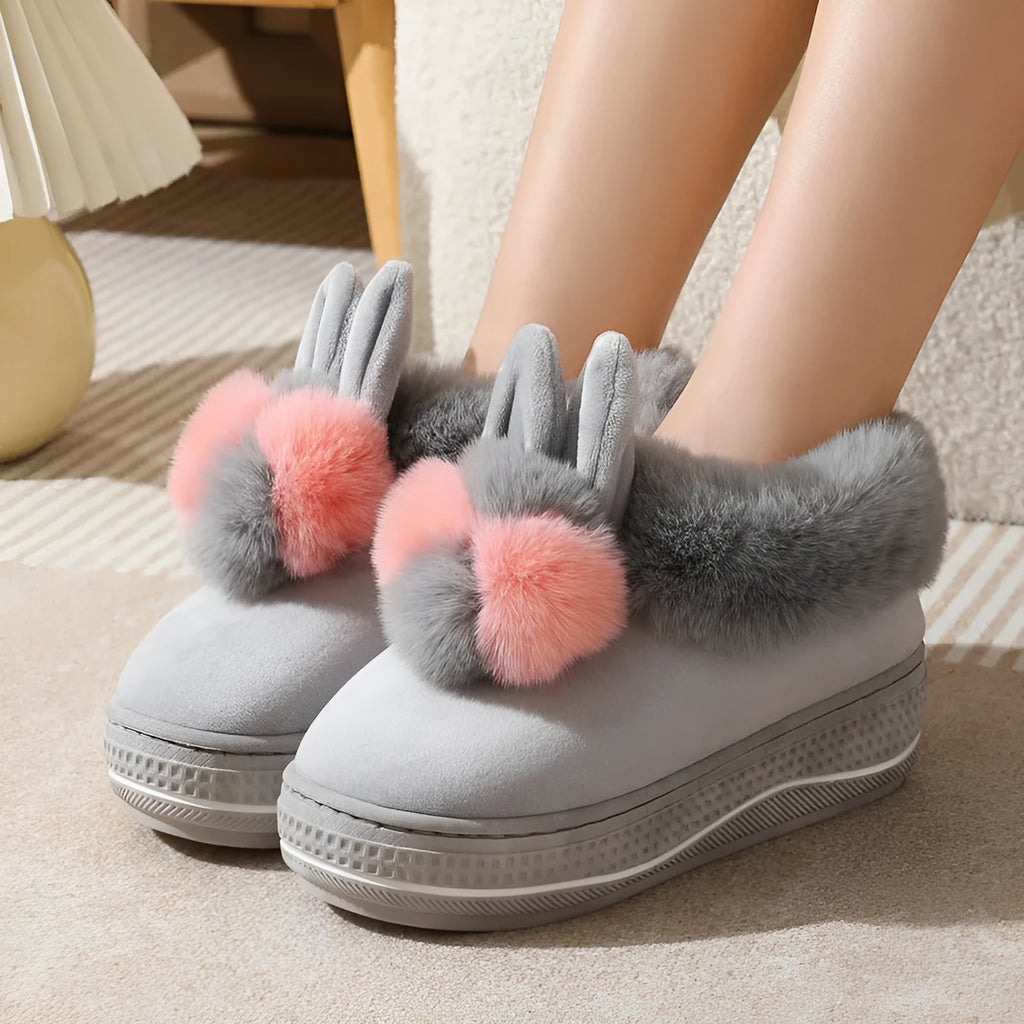Pair of grey cotton plush high heel slippers with a thick TPR sole, shown on a wooden floor.